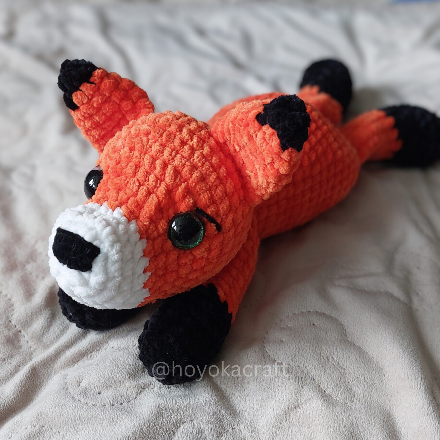 Fox lying down crochet plushie